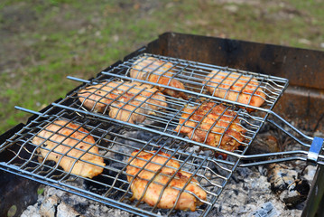 Barbecue chicken over an open fire in  summer