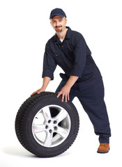 Fototapeta na wymiar Car mechanic with a tire.