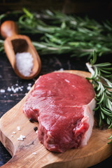 Raw steak with herbs and pepper
