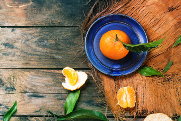 Tangerine on blue plate