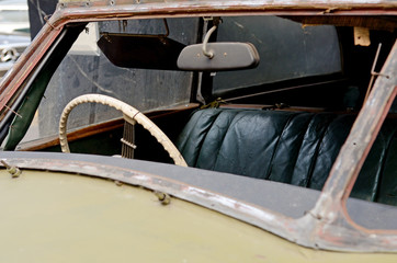 Fragment of rusted old car knocked front glass