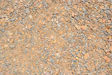 Black, red, blue stones and pebbles on a ground,