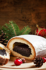 Christmas poppy seed roll, decorated with fir branches, cones, n