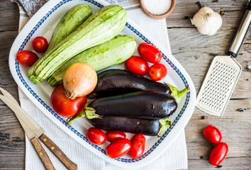 Fresh organic vegetables on a wooden table, top view