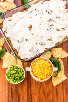 preparation of bean dip with jalapenos, sour cream and cheddar c