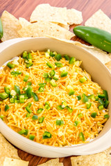preparation of bean dip with jalapenos, sour cream and cheddar c
