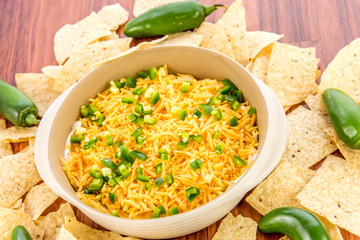 preparation of bean dip with jalapenos, sour cream and cheddar c