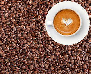Close-up of coffee beans and cup of coffee latte