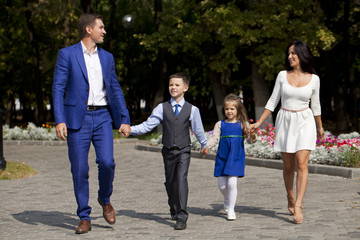 Happy Family Walking Along Suburban Street