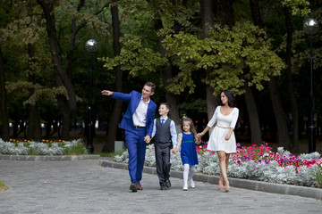 Obraz premium Happy Family Walking Along Suburban Street