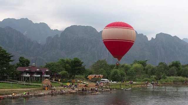 Balloon landing on the banks of the Nam Song river in Vang Vieng, Vientiane Province, Laos