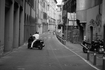 Motorcyclist driving along the narrow street