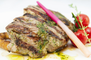 Grilled steak with sauce and greens on white background