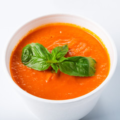 Hot food delivery - tomato gaspacho soup isolated