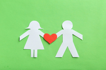 Paper people together in love on the green background