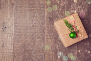 Christmas gift box with decorations on wooden background. View from above with copy space