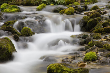 Fototapeta na wymiar mountain waterfall with green rock