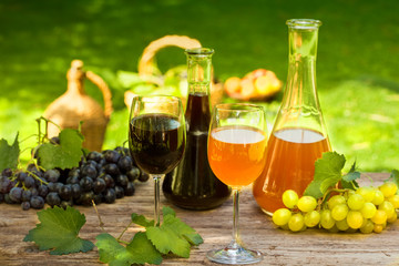 Wine in bottle carafes and glasses, with fresh fruit