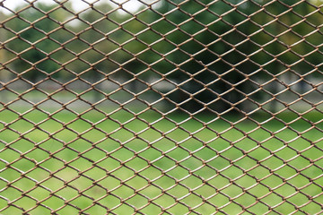Metal net with green blured background