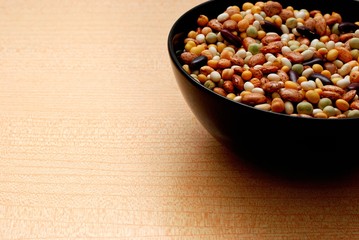 Black Bowl with Various Kind of Legumes,Orange Background