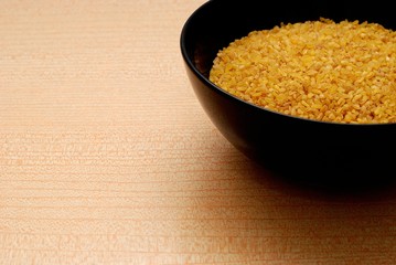 Black Bowl with Bulgur,Orange Background