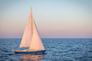 Fotobehang blue sailboat in the ocean © jaffarali