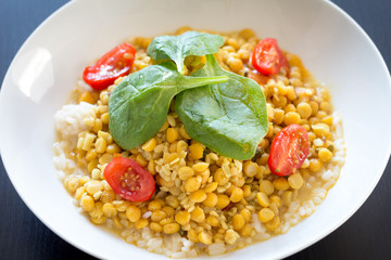 Lentils with rice and green spinach and tomatoes
