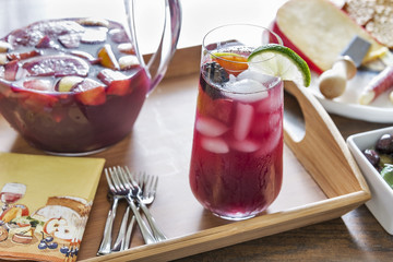 Glass filled with refreshing red sangria made with red wine and healthy fresh fruit like peaches, lemons, limes, oranges, berries and apples.  It is served with a variety of hors D'oeuvres.