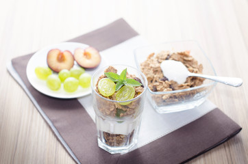 Breakfast od a table, consist of cereals, fruit, milk