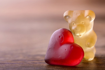 gummy bear with red heart on wood for valentines