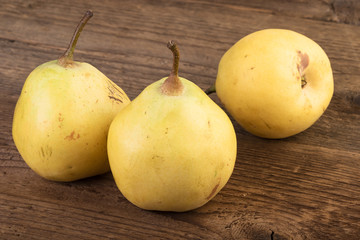 ripe pears over wood