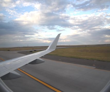 Plane taxiing down the runway seen through the window
