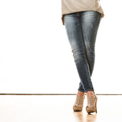 woman legs in denim trousers high heels shoes