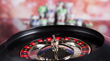 Fototapeta na wymiar Poker Chips on a gaming with casino roulette
