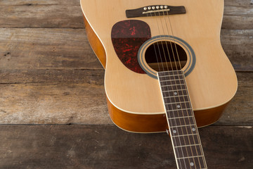 Close up acoustic guitar on old wood panel