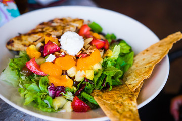 Healthy salad with grilled chicken and fruits
