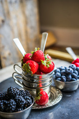 Mix of fresh berries on rustic background