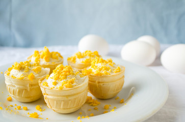 tartlet with cottage cheese, garlic and eggs on blue background