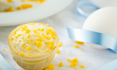 tartlet with cottage cheese, garlic and eggs on blue background