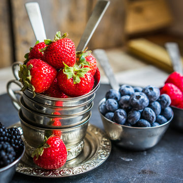 Mix of fresh berries on rustic background