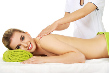 Young smile woman lying on a massage table and has massage.