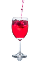 Red drink with ice cubes in a glass, Red soda in glass wine.