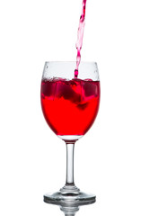 Red drink with ice cubes in a glass, Red soda in glass wine.