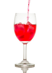 Red drink with ice cubes in a glass, Red soda in glass wine.