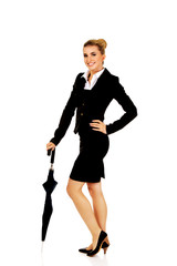 Attractive businesswoman holding an umbrella