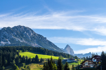 Fototapeta premium Landscape of mountains, green field, sky, forest in Filzmoos, Salzburg, Austria
