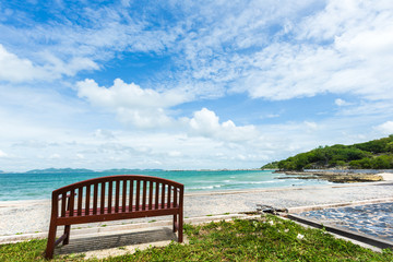 Chair on beach in sunny summer day viewing at the sea.