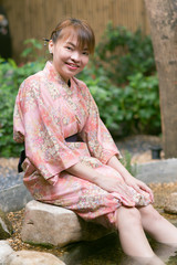 Asian woman wearing yukata in Asian garden