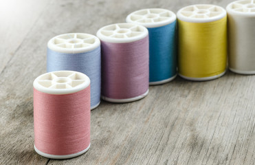 row of bobbins with thread
