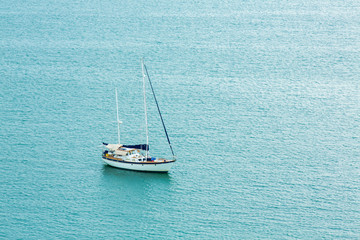 Fototapeta premium One alone boat in blue sea.